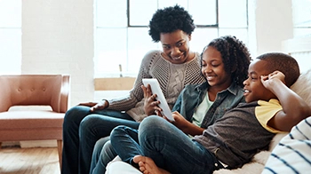 Madre e hijos utilizando una tableta juntos.