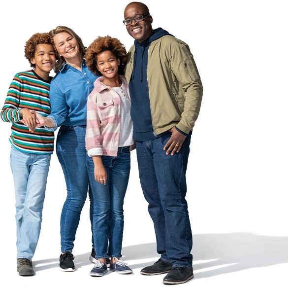 Una familia de cuatro, de pie y sonriendo